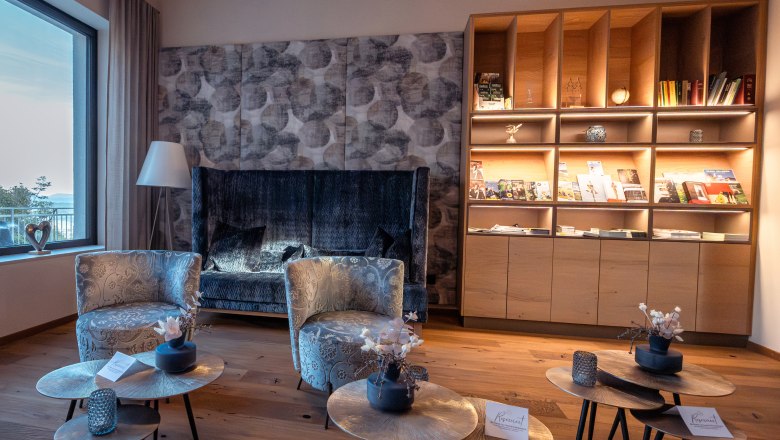 Hotel Schachner, © Niederösterreich Werbung / Maximilian Pawlikowsky Gemütlicher Hotel-Loungebereich mit Sesseln, Couchtischen und Bücherregal.