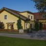 Gelbes Einfamilienhaus mit rotem Dach und Garten.
